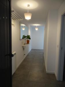 a hallway with white walls and a tile floor at That Little Place in Batalha in Batalha