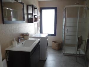 a bathroom with a sink and a toilet and a shower at That Little Place in Batalha in Batalha +39 photos