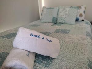 a towel sitting on top of a bed at Cantinho do Sonho in Maia