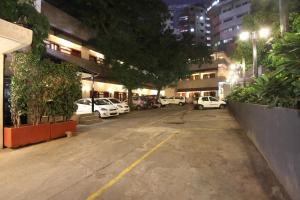 a parking lot with cars parked in a city at night at Taj Mahal Hotel Abids in Hyderabad