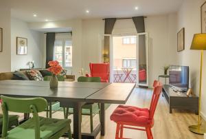 a living room with a dining room table and chairs at Bright & Very Comfortable Apartment in Valencia