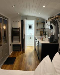a kitchen with a sink and a counter top at Luxury Shepherds Hut - The Sweet Pea by the lake in York