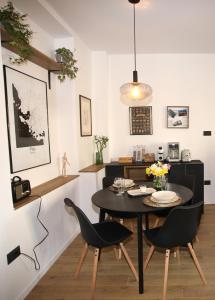 a dining room with a black table and chairs at Apartments INCIS next to the Pula Amphitheather in Pula