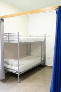 Litera con literas blancas en una habitación en Albergue Barullo - Cubículos - Literas - Habitaciones, en Sarria