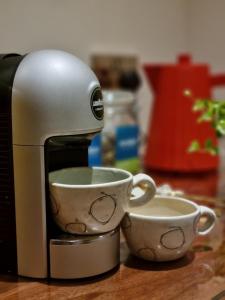 a coffee maker and two cups on a counter at Abhaig Boutique B&B - Small & luxurious in a great location! in Uig