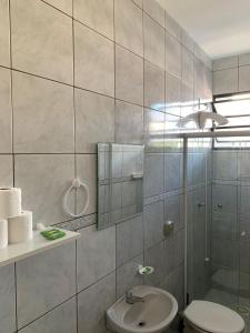 a bathroom with a toilet and a sink at Pousada Canasvieiras ABVO in Florianópolis