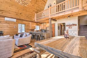 a dining room and living room with a wooden ceiling at A-Frame Cabin Near Hiking and Biking Trails! in Duck Creek Village
