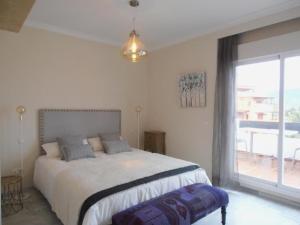 a bedroom with a bed and a large window at Playa Golf in Motril