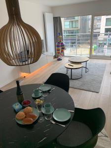 een zwarte tafel met eten erop in een kamer bij Zeezicht Oostduinkerke - Residentie Golfslag in Oostduinkerke