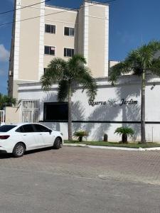 a white car parked in front of a building at Cantinho dos Rehm in Fortaleza