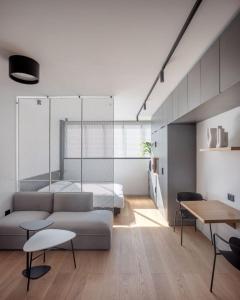 a living room with a couch and a table at DeBlox living - Ben Avigdor Apartments in Tel Aviv