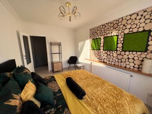 a bedroom with a bed and a wall of logs at Comfort Zone Ostróda Villa Apartment B in Ostróda