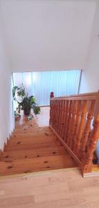 a wooden staircase in a house with a plant at VISOKO Room in Visoko