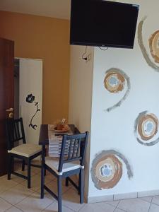a dining room with a table and chairs and a television at Il Faggio 17 B&B in Artena