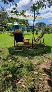 a picnic table and a bench under a tree at Hotel de Campo Villa de Ada in Gracias