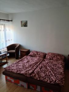 um quarto com uma cama com um edredão vermelho em Penzión Larix Blatnica em Blatnica