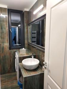 a bathroom with a white sink and a mirror at Bluemarina Apartamente in Mamaia +80 photos