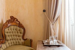 a room with a table with a chair and a window at Nafsimedon Hotel in Nafplio