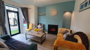 a living room with a couch and a fire place at Beulah Guest House in Portrush
