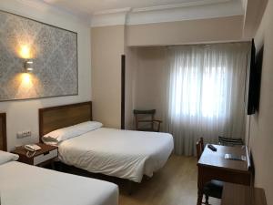 Posteľ alebo postele v izbe v ubytovaní Hostal La Mexicana