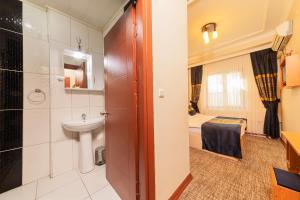 a bathroom with a sink and a toilet in a room at Vefa Hotel&Suites in Istanbul