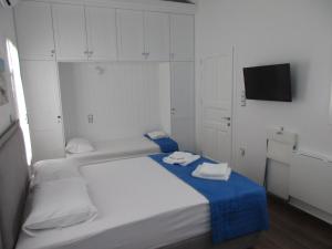 a bedroom with a bed with two towels on it at Spetses House - Near Kaiki Beach in Spetses