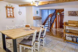 a dining room with a wooden table and chairs at Chalupa Tomas Ždiar in Ždiar