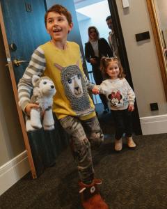 a young boy and a little girl standing in front of a mirror at De Ware Jacob Boutique Hotel in Amsterdam
