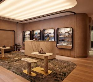 a lobby with two tables and two windows at Equinox Hotel New York in New York