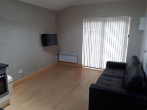 a living room with a couch and a large window at One double bedroom flat in Dublin