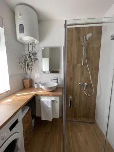 a bathroom with a shower with a sink and a toilet at Apartment Trogir City in Trogir +30 photos