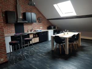 a kitchen with a table and chairs in a room at Cosy Lodg in Bourogne