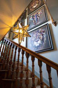 a star on a staircase with paintings on the wall at Vale House in Belvoir