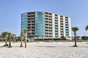 a building on the beach with palm trees in front at Spacious Biloxi Getaway with Pools and Beach Access! in Biloxi