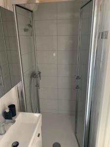 a bathroom with a shower and a sink at Inevig Holiday home in Rogoznica +64 photos