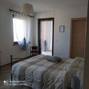 a bedroom with a bed and a window at Agriturismo La Ca' d'Amelio in Lessolo