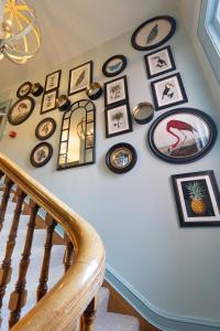 a staircase with a bunch of pictures on a wall at Vale House in Belvoir