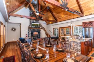 a dining room with a table and a fireplace at Heaven's Peak in Banner Elk