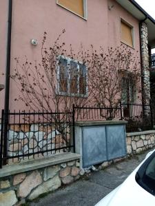 a pink house with a fence in front of it at Appartamento Turistico "ortensia" in Ancona