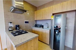 een keuken met een roestvrijstalen koelkast en een aanrecht bij ESPECTACULAR APTO AMPLIO DE 3 HAB UNICENTRO in Bogota