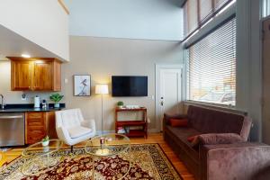 a living room with a couch and a table at The Loft Downtown in Joseph