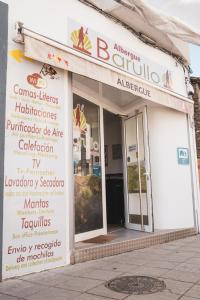 a building with a sign on the side of it at Albergue Barullo - Cubículos - Literas - Habitaciones in Sarria