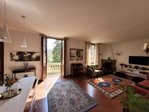 a living room with a couch and a table at Villa Lia - Apartment in Villa with private garden and Pool in Florence