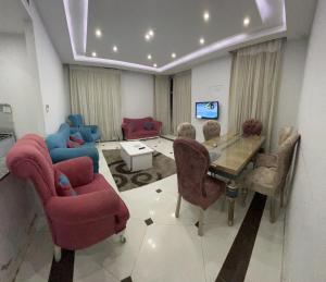 a living room with red chairs and a table at شقق بانوراما شاطئ الاسكندرية كود 13 in Alexandria