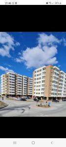 a parking lot with large white apartment buildings at Luxury Apartments in Bacău
