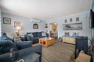 a living room with blue couches and a tv at ⭐️The Lucky 7 Beach House⭐️Water view⭐️4 bedroom⭐️ in Brigantine