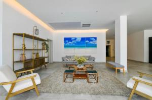 a living room with a couch and a table at Luxury condo with infinity pool & ocean view in Oranjestad