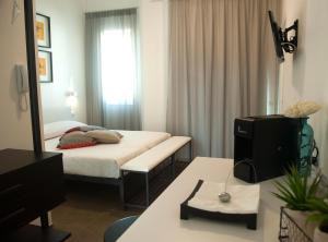 Habitación de hotel con cama y espejo en Via Del Faro Apartments, en Torre Canne
