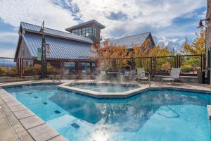 a swimming pool with a fountain in front of a building at Newpark Resort in Park City