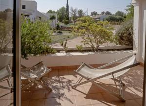 プラヤ・ミジョーンにあるViviendas Ferrer - Formentera Breakの庭の景色を望むバルコニー(椅子2脚付)
